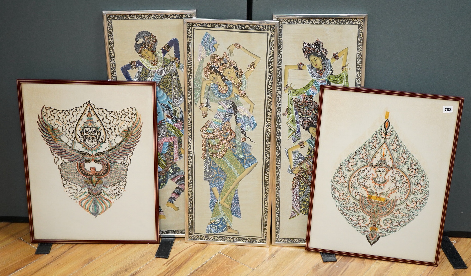 Two highly decorative coloured Thai cut-out pictures and three Thai paintings on fabric of Thai Dancers, largest 82 x 28cm